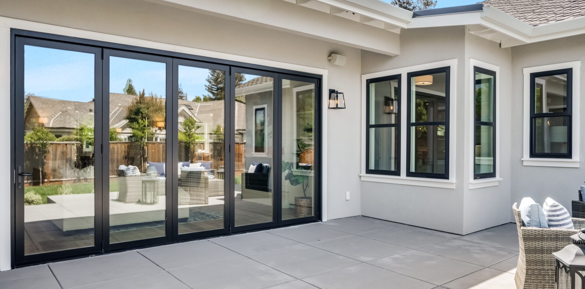 A patio with sliding glass doors and a large window.