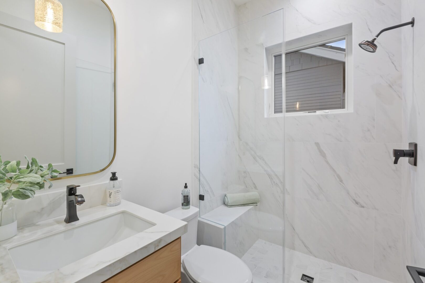 A bathroom with white walls and marble floors.